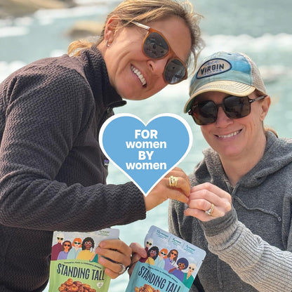 Two women holding standing tall snacks and living a healthy life enjoying life