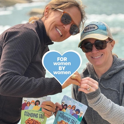 Two women standing tall snacks and living a healthy life enjoying life